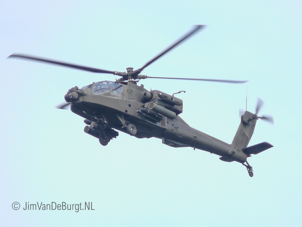 Ein militärisches Chinook-Hubschrauber fliegt mit ausgefahrenem Fahrwerk, seine beiden Rotoren drehen sich schnell.